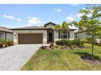 Charming single-story home with a well-maintained lawn and lush landscaping at 1734 Saddlewood Cir, Port Charlotte, FL 33953