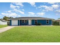 Charming single-story home boasts a well-manicured lawn and attached garage at 2420 Linton Ln, Port Charlotte, FL 33952