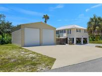 Charming elevated home with a two car garage and a large paved parking area at 3616 Allapatchee Dr, Punta Gorda, FL 33950