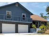 View of home's exterior showcasing the attached garage and landscaped entrance at 6421 Grove Blvd, Punta Gorda, FL 33982