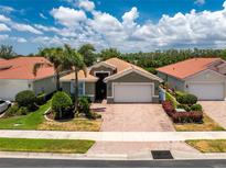 Charming one-story home featuring a brick driveway, attached two-car garage and lush landscaping at 11666 Parrotfish St, Venice, FL 34292
