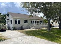 Charming single-story home featuring a spacious front porch and well-maintained lawn at 1250 Lemon St, Punta Gorda, FL 33950