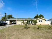 Charming single-story home with a well-maintained lawn and a convenient carport at 3122 Scranton St, Port Charlotte, FL 33952