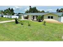 Charming single-story home with a well-manicured lawn and mature trees in a desirable neighborhood at 3122 Scranton St, Port Charlotte, FL 33952