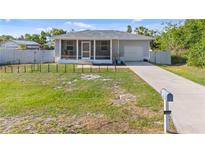 Charming single-story home with a screened-in porch, driveway, and well-maintained lawn and minimal landscaping at 4702 Westwood Dr, Punta Gorda, FL 33982