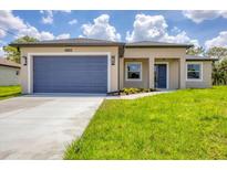Charming single-story home with a well-manicured lawn, attached garage, and inviting entrance at 4862 Kiska Rd, North Port, FL 34288