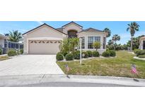 Charming single-story home with well-manicured landscaping and a two-car garage at 10263 Shadow Run Cir, Punta Gorda, FL 33955