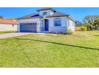 Charming single Gathering home with a manicured lawn and a two car garage at 122 Arrow Ln, Rotonda West, FL 33947