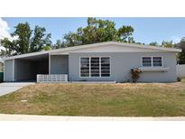 Charming single-story home with a well-maintained lawn and covered parking at 21275 Austin Ave, Port Charlotte, FL 33952
