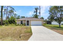 Beautiful single-story home featuring a well-kept lawn, an extended driveway, and an attached two-car garage at 3799 Laredo Ave, North Port, FL 34288