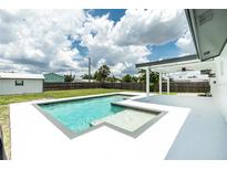Inviting pool with integrated spa and covered patio, perfect for outdoor entertaining at 416 Allen St, Punta Gorda, FL 33950