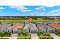 Stunning single-story home with well manicured landscaping and beautiful water view and golf course backdrop at 43406 Boardwalk Loop, Punta Gorda, FL 33982