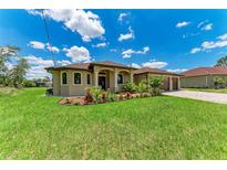Charming single-Gathering home with a well-manicured lawn and tropical landscaping at 4380 Maddock Cir, North Port, FL 34286