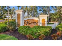 Elegant community sign for Vivante at Punta Gorda, surrounded by lush landscaping and mature trees at 99 Vivante Blvd # 310, Punta Gorda, FL 33950