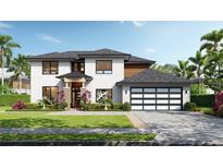 Elegant two-story home boasts lush landscaping, a stylish garage door, and a welcoming front entrance at 12299 Albrecht Ter, Port Charlotte, FL 33981