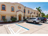 Attractive building exterior featuring multiple units, designated parking and tropical landscaping at 1236 Rio De Janeiro Ave # 406, Punta Gorda, FL 33983