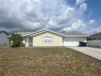 Charming single-story home with attached garage, neat landscaping, and inviting curb appeal at 2696 Gisela Rd, North Port, FL 34287