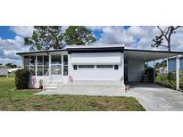 Charming single-story home featuring a covered carport and well-maintained landscaping at 6843 Amoko Ct, North Port, FL 34287