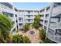 Three story courtyard with a fountain, decorative brick, and stairs to each floor at 2001 Bal Harbor Blvd # 2306, Punta Gorda, FL 33950