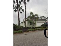 Charming single-Gathering home with well-manicured landscaping, palm trees, and a two-car garage enhancing curb appeal at 24016 Buckingham Way, Punta Gorda, FL 33980