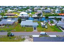 Waterfront home with a metal roof, canal access, and RV/boat parking on a grassy lot, located in a waterfront community at 24239 Yacht Club Blvd, Punta Gorda, FL 33955
