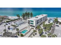 Stunning aerial view of a beachfront condo with a private pool, showcasing its prime location and coastal charm at 2590 N Beach Rd # 5, Englewood, FL 34223