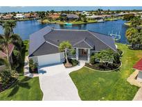 Stunning waterfront home with a well-manicured lawn and a private boat dock at 261 Venezia Ct, Punta Gorda, FL 33950