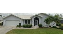 Charming single-story home with a well-manicured lawn and beautiful landscaping at 3233 Meadow Run Dr, Venice, FL 34293
