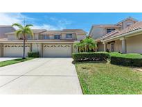 Charming townhome exterior with two-car garage, tile roof, and well-maintained landscaping at 3800 Bal Harbor Blvd # 414, Punta Gorda, FL 33950