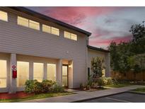 Charming two-story townhome with a well-manicured lawn and beautiful landscaping at dusk at 4346 Rayfield Dr # 4346, Sarasota, FL 34243