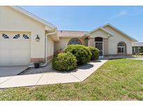 Charming single-story home features a well-maintained lawn and beautiful landscaping at 7334 N Tulip Tree, Punta Gorda, FL 33955