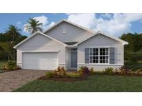 Charming single-story home featuring a brick driveway, two-car garage, and well-manicured landscaping at 9710 Sand Dune Ln, Punta Gorda, FL 33950