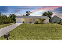 Charming single-story home with a well-maintained lawn and a cozy, inviting facade at 10133 Gulfstream Blvd, Englewood, FL 34224