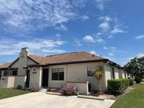 Charming condo featuring a stucco exterior, well-maintained landscaping, and neutral tones at 13100 S Mccall Rd # 125, Port Charlotte, FL 33981
