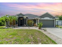 Charming single-story home with a well-maintained lawn and inviting curb appeal in a serene setting at 1444 Frisco Ter, Port Charlotte, FL 33953