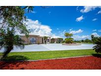 Elegant single-Gathering home with a spacious driveway, lush lawn, and meticulously maintained landscaping at 17400 White Water Ct, Punta Gorda, FL 33982