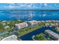 Stunning aerial view of waterfront condos offering beautiful views and convenient access to the water at 25188 Marion Ave # F202, Punta Gorda, FL 33950