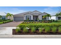 Charming single-story home with manicured lawn, stone driveway, and inviting curb appeal at 42346 Waterfront Way, Punta Gorda, FL 33982