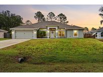 Charming single-story home featuring a well-manicured lawn and a welcoming front entrance at 5436 Jessamine Ave, North Port, FL 34291