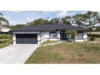 Charming single-story home featuring a spacious two-car garage and freshly manicured lawn at 6794 Loffreda Ave, North Port, FL 34291