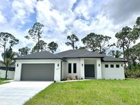 Beautiful one-story home with a well-manicured lawn and attached two-car garage at 2089 Garnet St, North Port, FL 34288