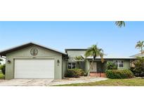 Charming home with an attached two-car garage and mature landscaping at 2160 Aqui Esta Dr, Punta Gorda, FL 33950