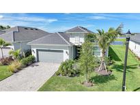 Beautiful exterior view of the home, featuring a gray roof, a driveway, and landscaping at 15039 Black Cherry Way, Punta Gorda, FL 33955