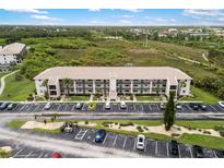 Attractive three-story condo complex showcasing manicured landscaping and abundant parking at 175 Kings Hwy # 625, Punta Gorda, FL 33983