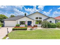 Charming single Gathering home with manicured lawn, flower beds, and dark tile roof at 3724 Bordeaux Dr, Punta Gorda, FL 33950