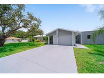 Charming single-story home with a well-maintained lawn, spacious driveway, and attached one-car garage at 405 Ridgecrest Dr, Punta Gorda, FL 33982