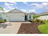 Charming single-story home with a two-car garage, manicured landscaping, and a welcoming entrance at 42771 Valley Brooks St, Punta Gorda, FL 33982