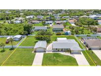 Expansive aerial view of a single-Gathering home with a spacious yard and a detached two-car garage at 4509 Wynkoop Cir, Port Charlotte, FL 33948