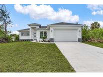 Beautiful single Gathering home with a well-manicured lawn and a two-car garage at 165 Ingram Blvd, Rotonda West, FL 33947