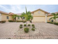 Charming single-story home with a brick driveway, well-manicured landscaping and a two-car garage at 1527 Aqui Esta Dr # 3, Punta Gorda, FL 33950